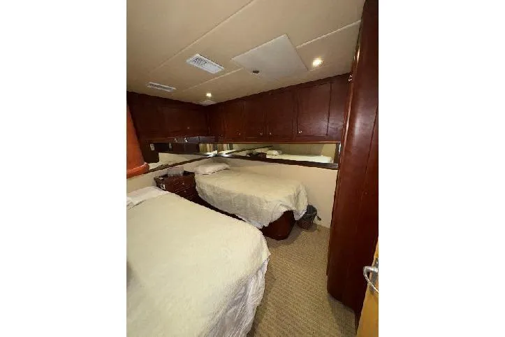 Slide: The Image of Interior cabin of 1994 Bertram 60 Convertible yacht with twin beds and wooden cabinetry. - 15