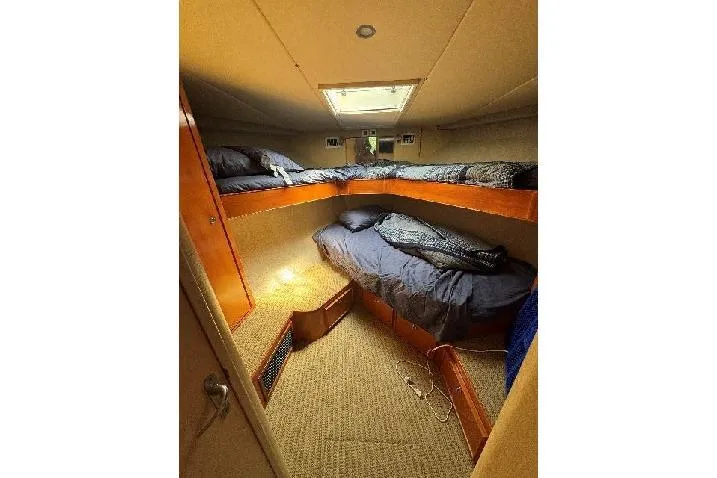 Slide: The Image of Cozy cabin interior of 1994 Bertram 60 Convertible yacht with bunk beds. - 16