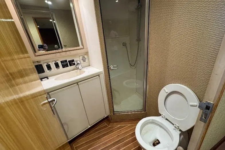 Slide: The Image of Bathroom interior of a 1994 Bertram 60 Convertible yacht with shower and toilet. - 18