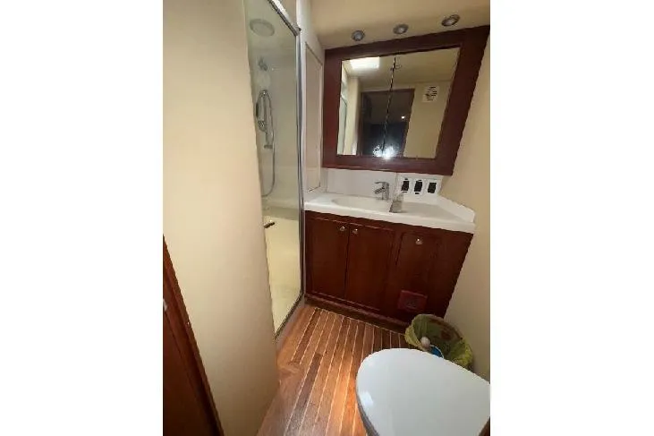 Slide: The Image of Bathroom interior of 1994 Bertram 60 Convertible yacht with wood flooring and shower. - 19