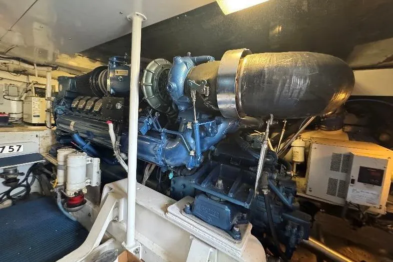 Slide: The Image of Engine room of a 1994 Bertram 60 Convertible yacht, showcasing a powerful marine engine. - 21