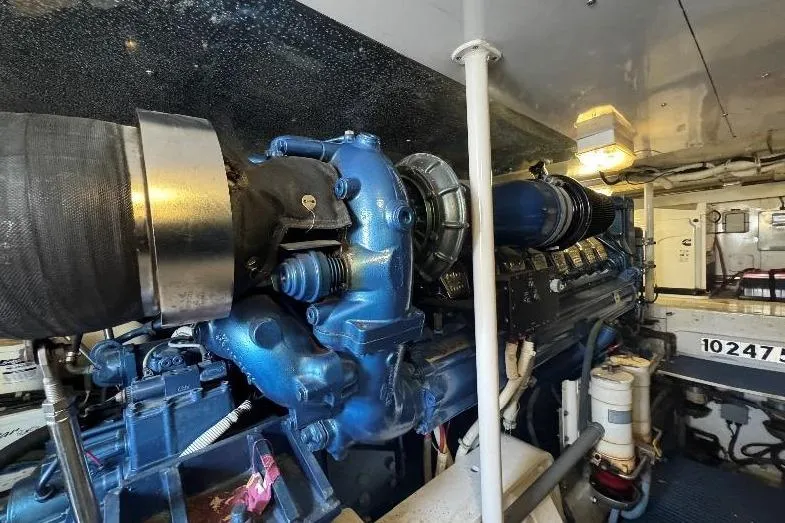 Slide: The Image of Engine room of a 1994 Bertram 60 Convertible yacht, showcasing a powerful marine engine. - 22