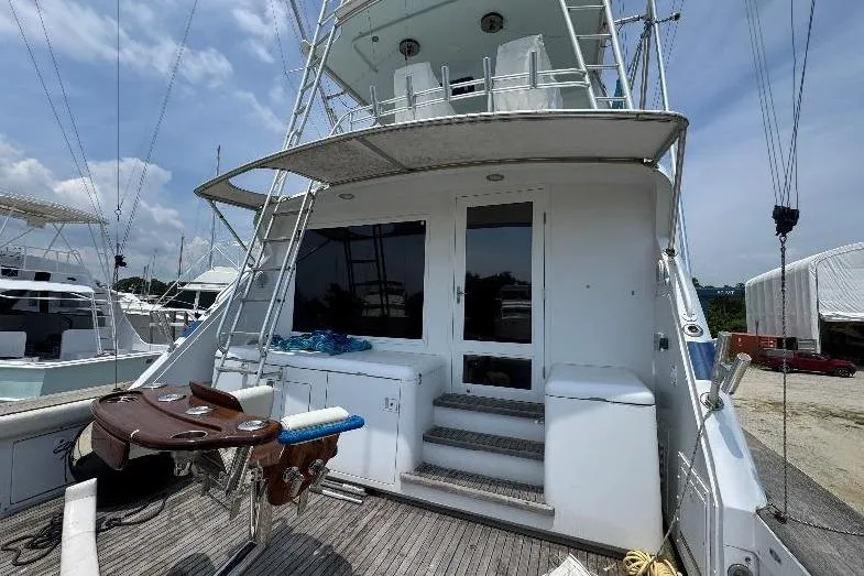 Slide: The Image of 1994 Bertram 60 Convertible yacht with spacious deck and fishing chair. - 4