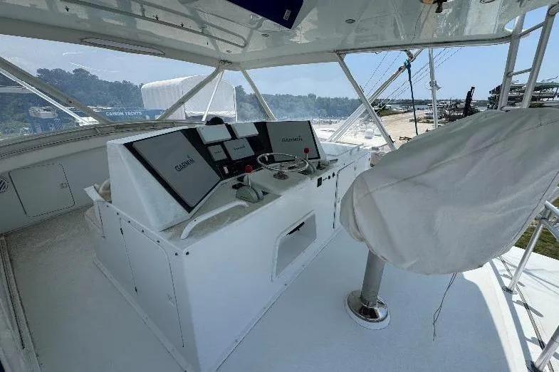 Slide: The Image of 1994 Bertram 60 Convertible yacht helm with Garmin navigation system and covered captain's chair. - 5