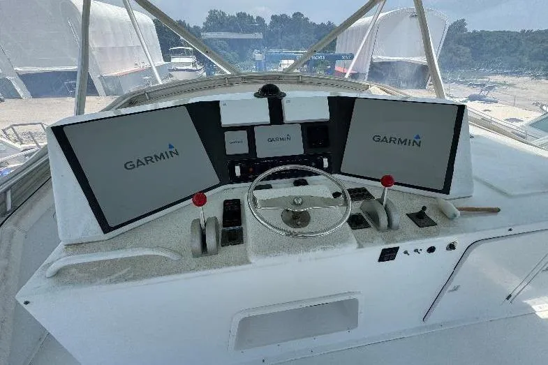 Slide: The Image of 1994 Bertram 60 Convertible helm with Garmin navigation displays and steering wheel. - 6