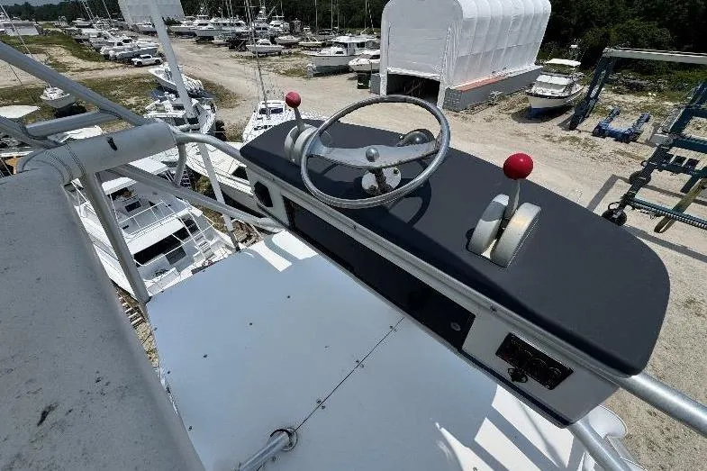Slide: The Image of Helm of 1994 Bertram 60 Convertible yacht with steering wheel and controls. - 7