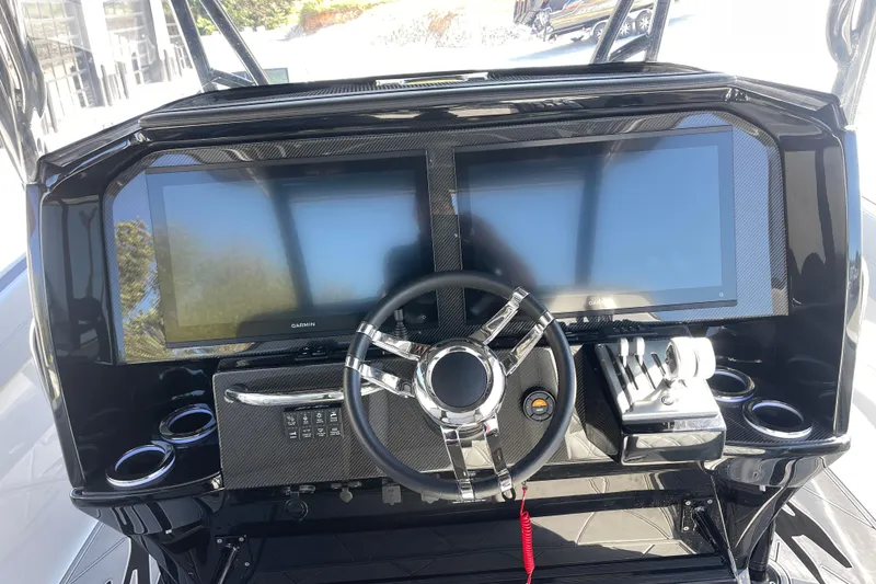 Slide: The Image of 2026 Nor-Tech 340 Sport Center Console dashboard with dual screens and modern controls. - 11