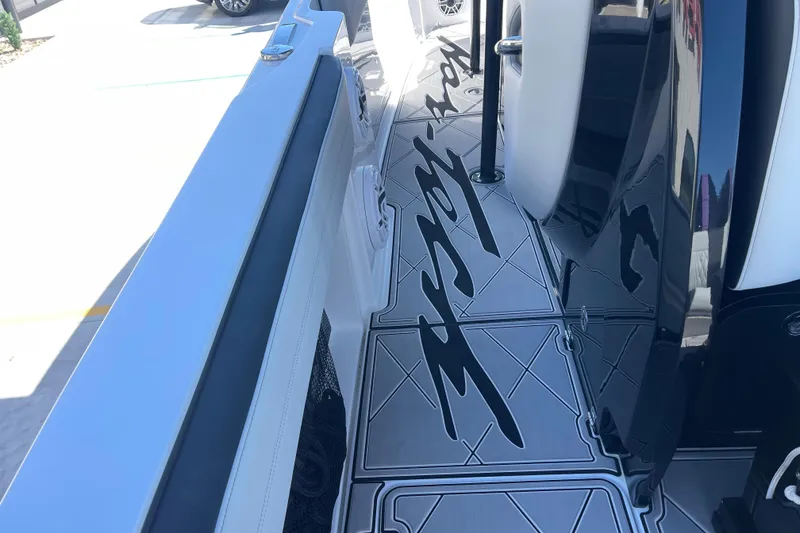 Slide: The Image of 2026 Nor-Tech 340 Sport Center Console boat with sleek deck design. - 12