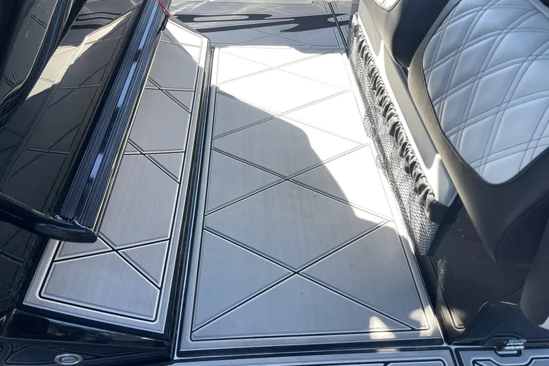 Slide: The Image of 2026 Nor-Tech 340 Sport Center Console interior with sleek, modern flooring and cushioned seating. - 14