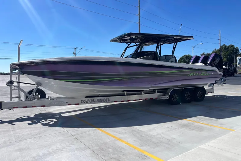 Slide: The Image of 2026 Nor-Tech 340 Sport Center Console boat on trailer, parked in sunny lot. - 4