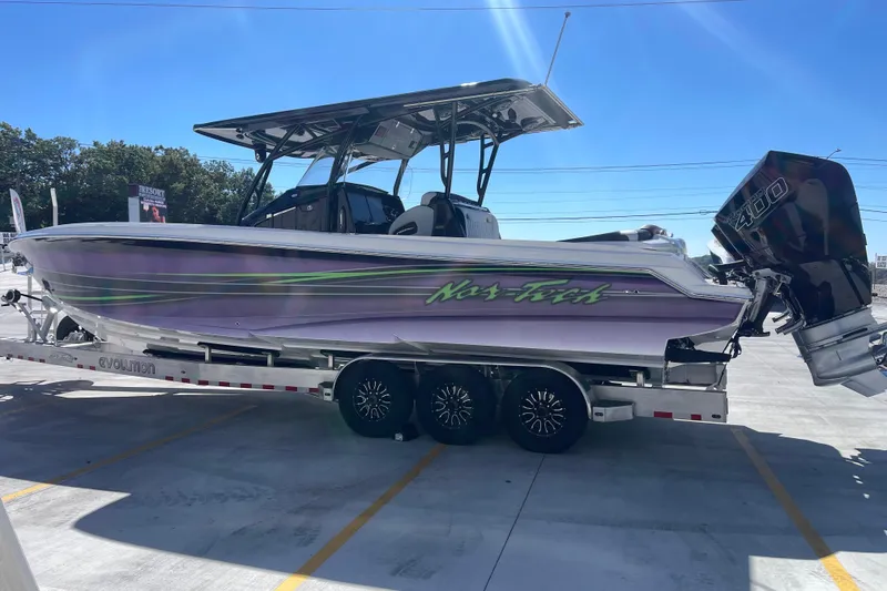 Slide: The Image of 2026 Nor-Tech 340 Sport Center Console boat on trailer, featuring sleek design and powerful engines. - 6