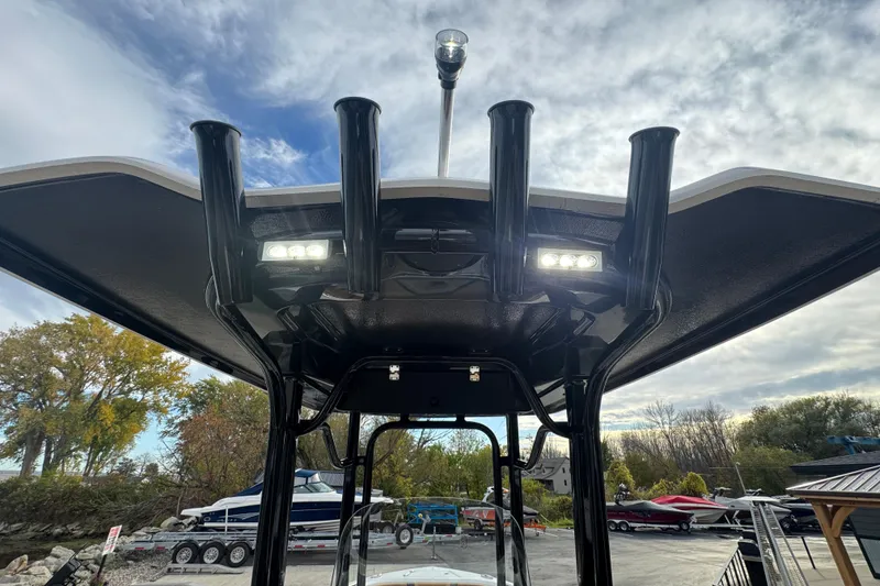 Slide: The Image of 2024 Robalo R230 Center Console boat with T-top and rod holders. - 11