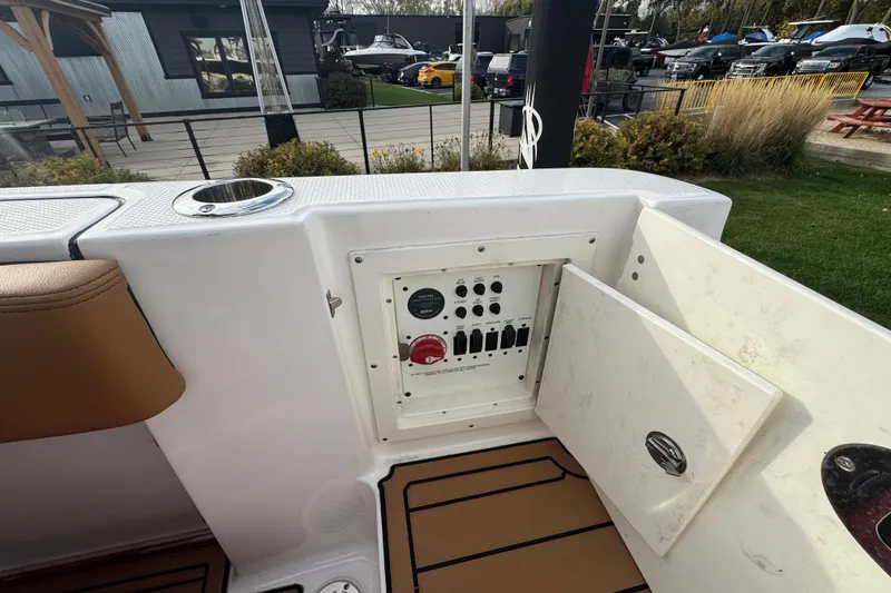 Slide: The Image of 2024 Robalo R230 Center Console boat electrical panel with open access door. - 12