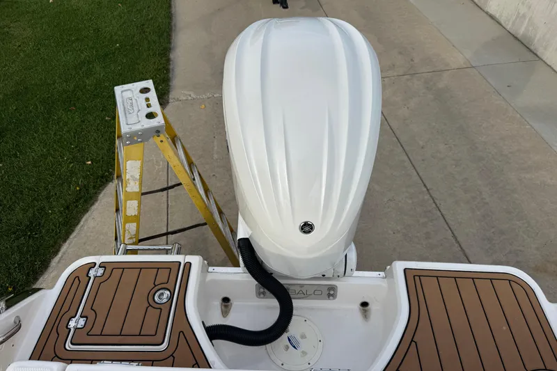 Slide: The Image of 2024 Robalo R230 Center Console boat with Yamaha outboard motor, docked on concrete. - 14