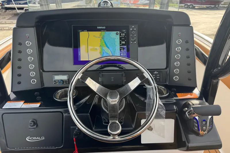Slide: The Image of 2024 Robalo R230 Center Console dashboard with steering wheel and navigation display. - 15