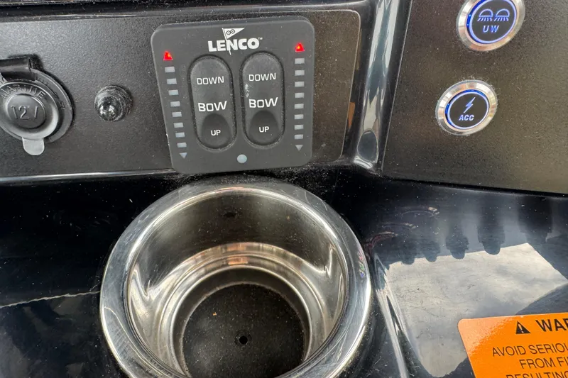 Slide: The Image of 2024 Robalo R230 Center Console dashboard with Lenco controls and cup holder. - 19