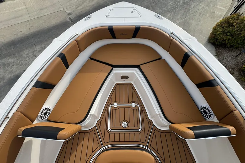 Slide: The Image of 2024 Robalo R230 Center Console boat with tan seating and wood-patterned flooring. - 21