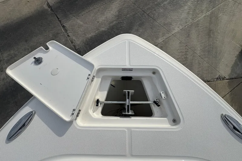Slide: The Image of 2024 Robalo R230 Center Console anchor compartment with open hatch. - 23