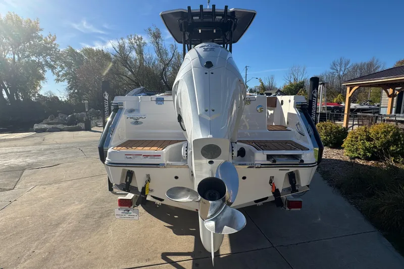 Slide: The Image of 2024 Robalo R230 Center Console boat, rear view with outboard motor, parked outdoors. - 5