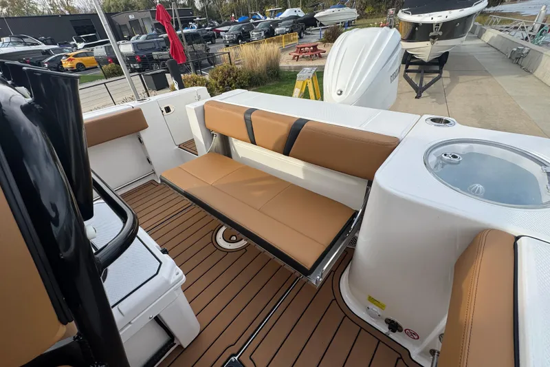 Slide: The Image of 2024 Robalo R230 Center Console boat interior with tan seating and deck. - 6