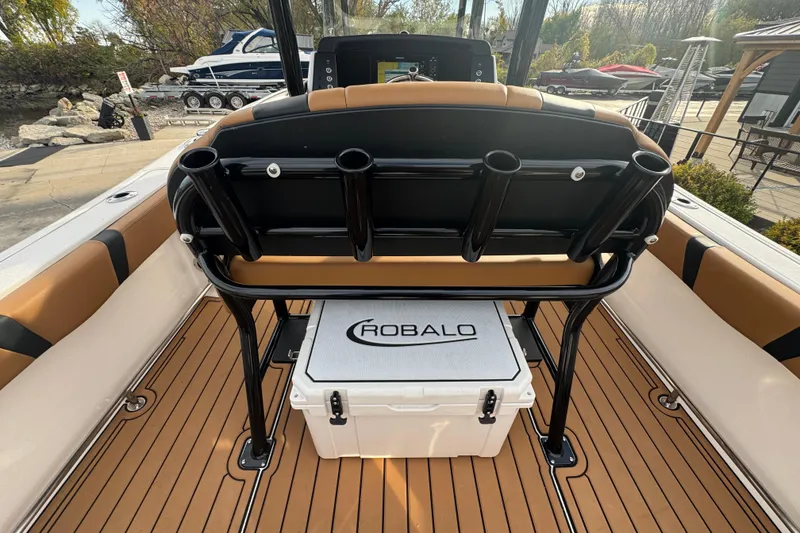 Slide: The Image of 2024 Robalo R230 Center Console boat interior with rod holders and branded cooler. - 7