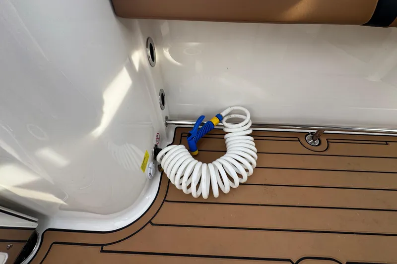 Slide: The Image of Coiled hose on 2024 Robalo R230 Center Console boat deck. - 9