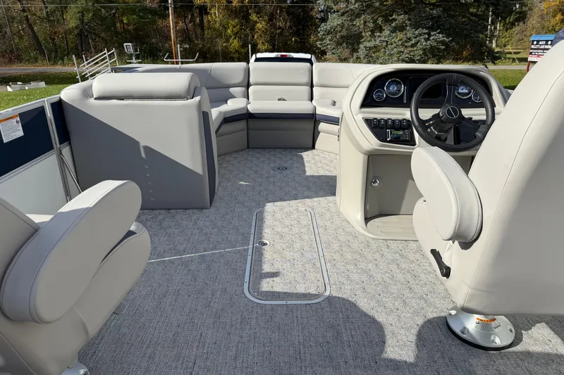 Slide: The Image of 2026 Berkshire 24 UL LE pontoon boat interior with plush seating and modern helm. - 10