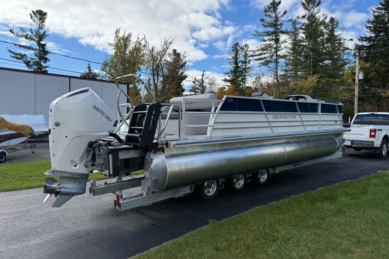 Slide: The Image of 2026 Berkshire 24 UL LE pontoon boat with Mercury outboard motor on trailer. - 2