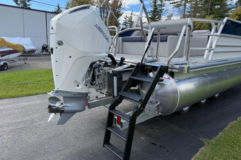Slide: The Image of 2026 Berkshire 24 UL LE pontoon boat with Mercury outboard motor and boarding ladder. - 4