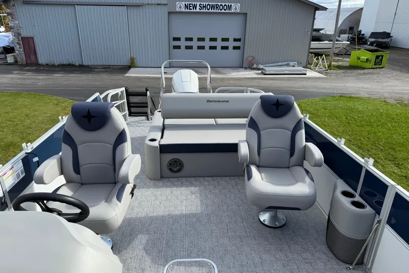 Slide: The Image of 2026 Berkshire 24 UL LE pontoon boat interior with plush seating, showcased at a showroom. - 6
