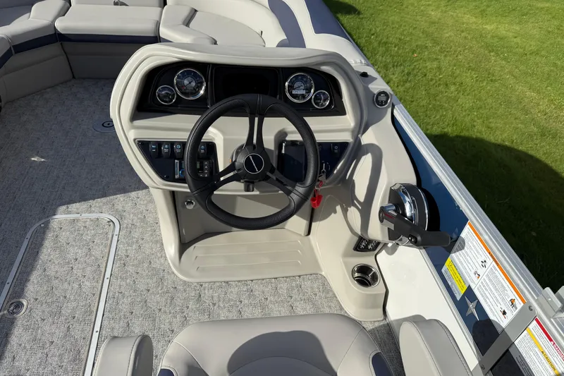 Slide: The Image of 2026 Berkshire 24 UL LE boat helm with steering wheel and control panel. - 9