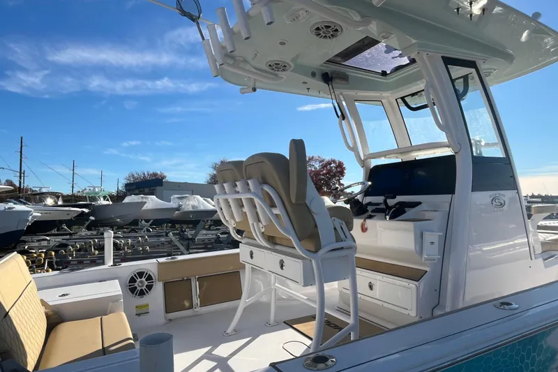 Slide: The Image of 2024 Sportsman Masters 247OE Bay Boat interior with seating and helm station. - 11