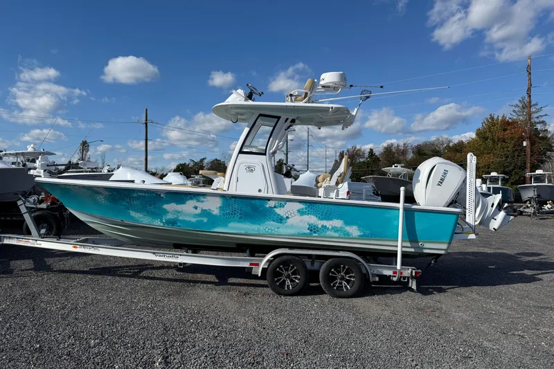 Slide: The Image of 2024 Sportsman Masters 247OE Bay Boat on trailer under blue sky. - 15