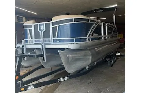 Slide: The Image of 2020 MONACO 235C pontoon boat on trailer in storage. - 2