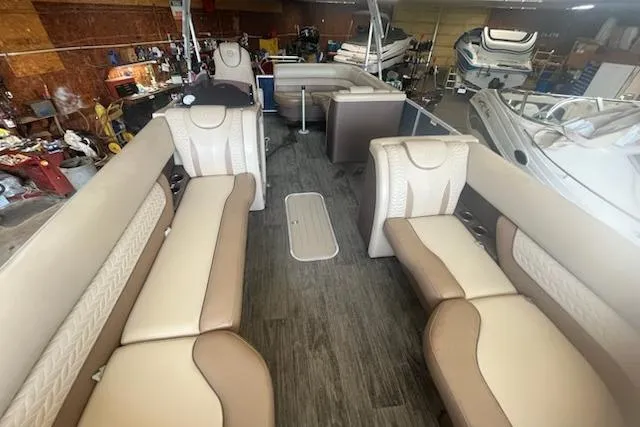 Slide: The Image of 2020 MONACO 235C boat interior with beige seating in a workshop setting. - 5
