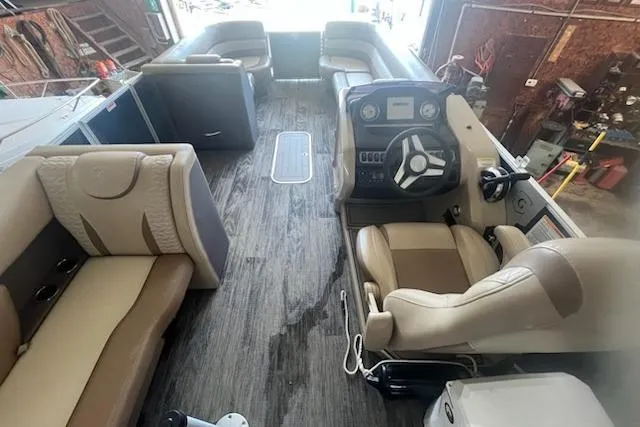 Slide: The Image of Interior of a 2020 MONACO 235C boat with beige seating and steering console. - 9