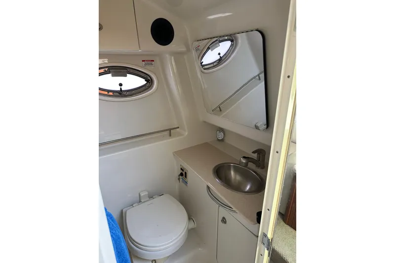 Slide: The Image of Compact bathroom in 2008 Sea Ray 290 Sundancer boat with sink, toilet, and mirror. - 17