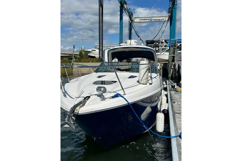 Slide: The Image of 2008 Sea Ray 290 Sundancer docked at marina, blue hull, sunny day. - 2