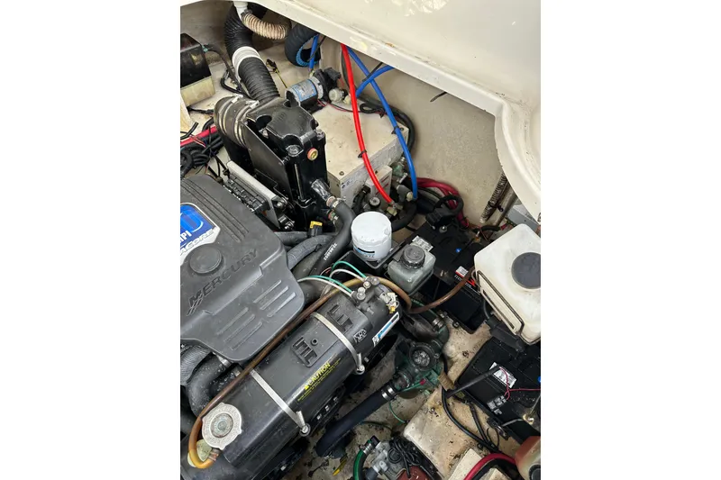 Slide: The Image of Engine compartment of a 2008 Sea Ray 290 Sundancer boat, featuring Mercury components. - 23
