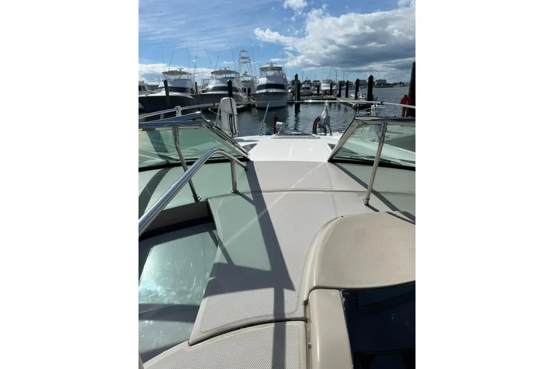 Slide: The Image of 2008 Sea Ray 290 Sundancer boat docked at marina under blue sky. - 6