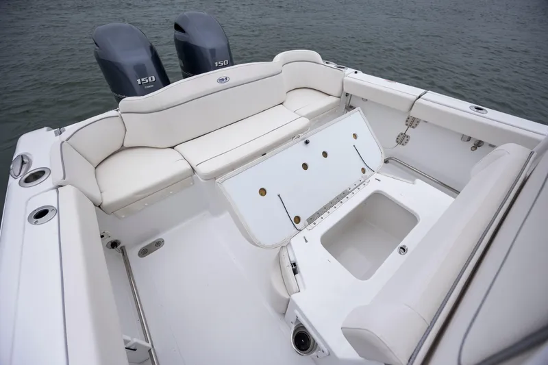 Slide: The Image of 2023 Sea Hunt Ultra 265 SE boat interior with seating and storage compartments. - 12