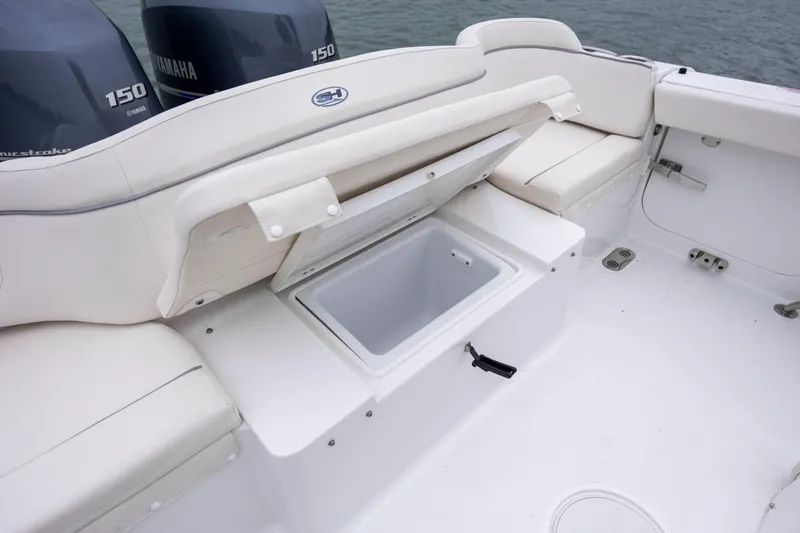 Slide: The Image of 2023 Sea Hunt Ultra 265 SE boat interior with open storage compartment. - 13
