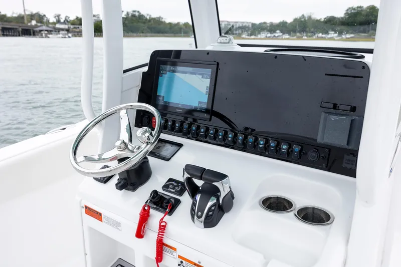 Slide: The Image of 2023 Sea Hunt Ultra 265 SE boat dashboard with steering wheel and navigation system. - 15
