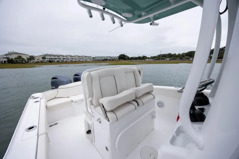 Slide: The Image of 2023 Sea Hunt Ultra 265 SE boat interior with seating and water view. - 17
