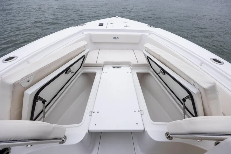 Slide: The Image of 2023 Sea Hunt Ultra 265 SE boat interior with open storage compartments. - 21