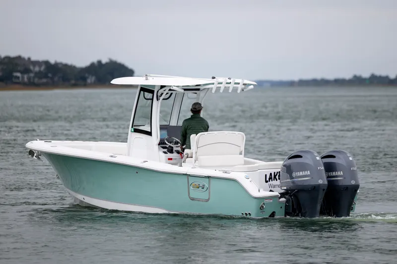 Slide: The Image of 2023 Sea Hunt Ultra 265 SE boat with dual Yamaha engines on water. - 3
