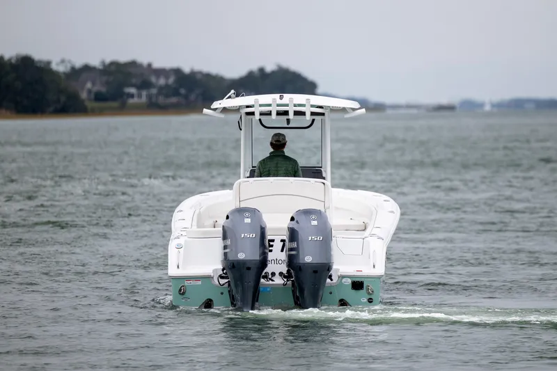 Slide: The Image of 2023 Sea Hunt Ultra 265 SE boat cruising on a calm waterway. - 4
