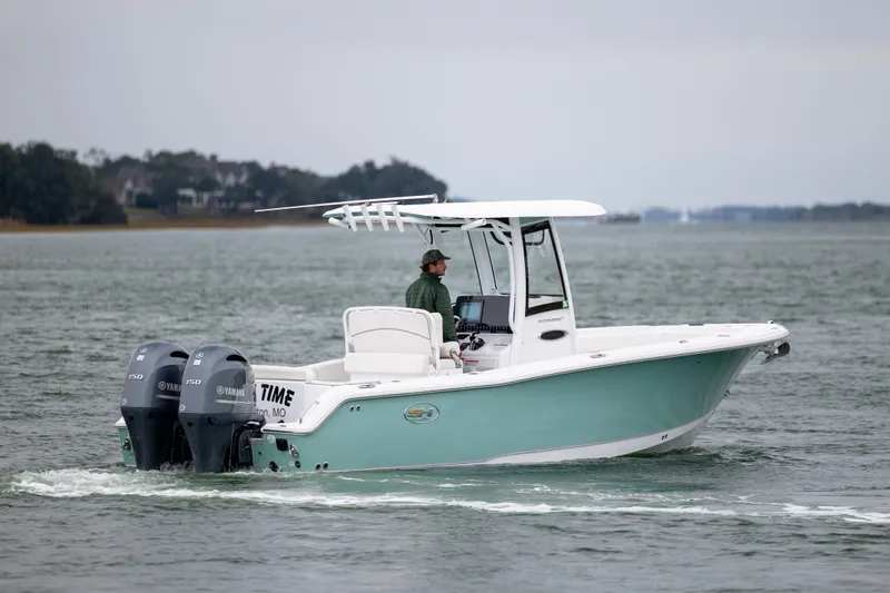 Slide: The Image of 2023 Sea Hunt Ultra 265 SE boat cruising on a calm waterway. - 5