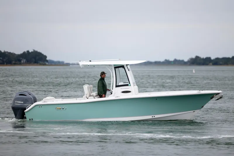 Slide: The Image of 2023 Sea Hunt Ultra 265 SE boat cruising on calm waters with a Yamaha engine. - 6