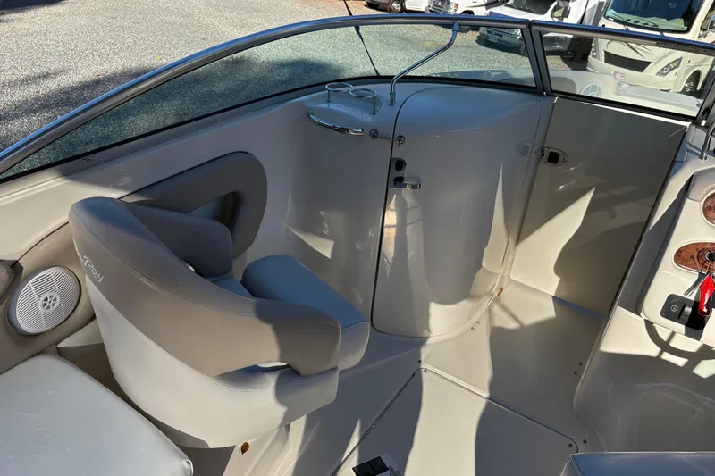Slide: The Image of 2004 Sea Ray 240 Sundeck interior with seating and control panel. - 14
